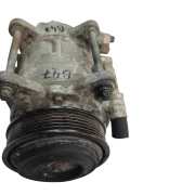 Front view of a genuine used BMW B47 air conditioning compressor, showing the ribbed drive pulley and factory mounting bolts.