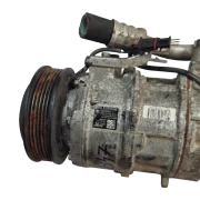 Close up of the factory Denso identification sticker on a BMW B47 A/C compressor, showing part number 64529299328 and model 6SAS14A. 3.