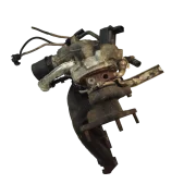 Angled side view of a salvaged VW / Audi 2.0 TDI turbocharger, showing the attached oil lines, actuator, and heat shielding.