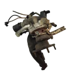 Angled side view of a salvaged VW / Audi 2.0 TDI turbocharger, showing the attached oil lines, actuator, and heat shielding.